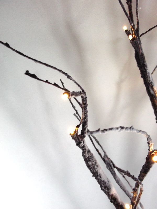 showing Artificial LED Snowy Twig Tree with base and wire - Close up of LED and branch Against White Background